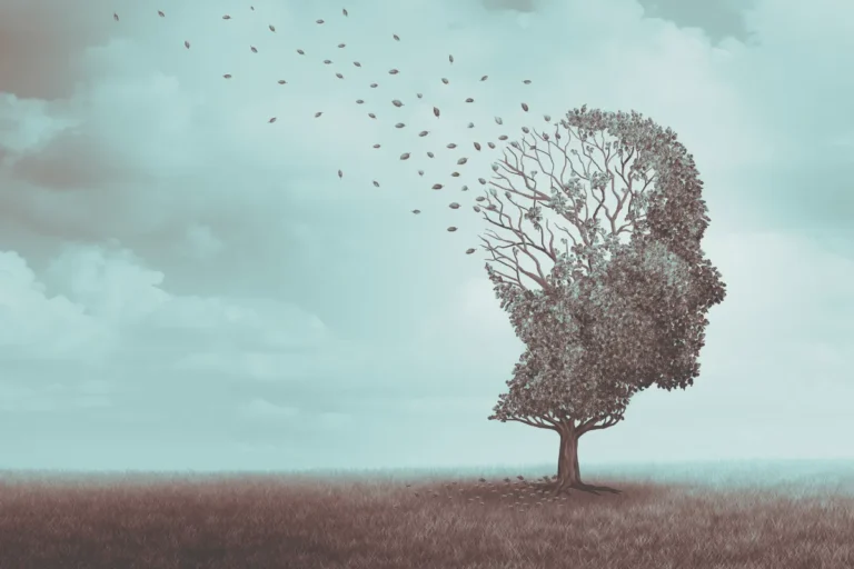 Künstlerische Darstellung eines Baum-Kopf-Profils mit wegfliegenden Blättern vor türkisfarbenem Himmel. Demenz und Gedächtnisverlust